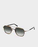 A pair of Masunaga GMS115 S43 sunglasses with a hexagonal shape and brown frame.