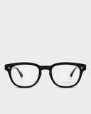 Black eyeglasses with gold accents on a white background