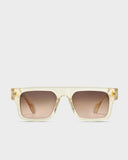A pair of square-shaped, champagne gold sunglasses with a clear frame and tinted lenses.